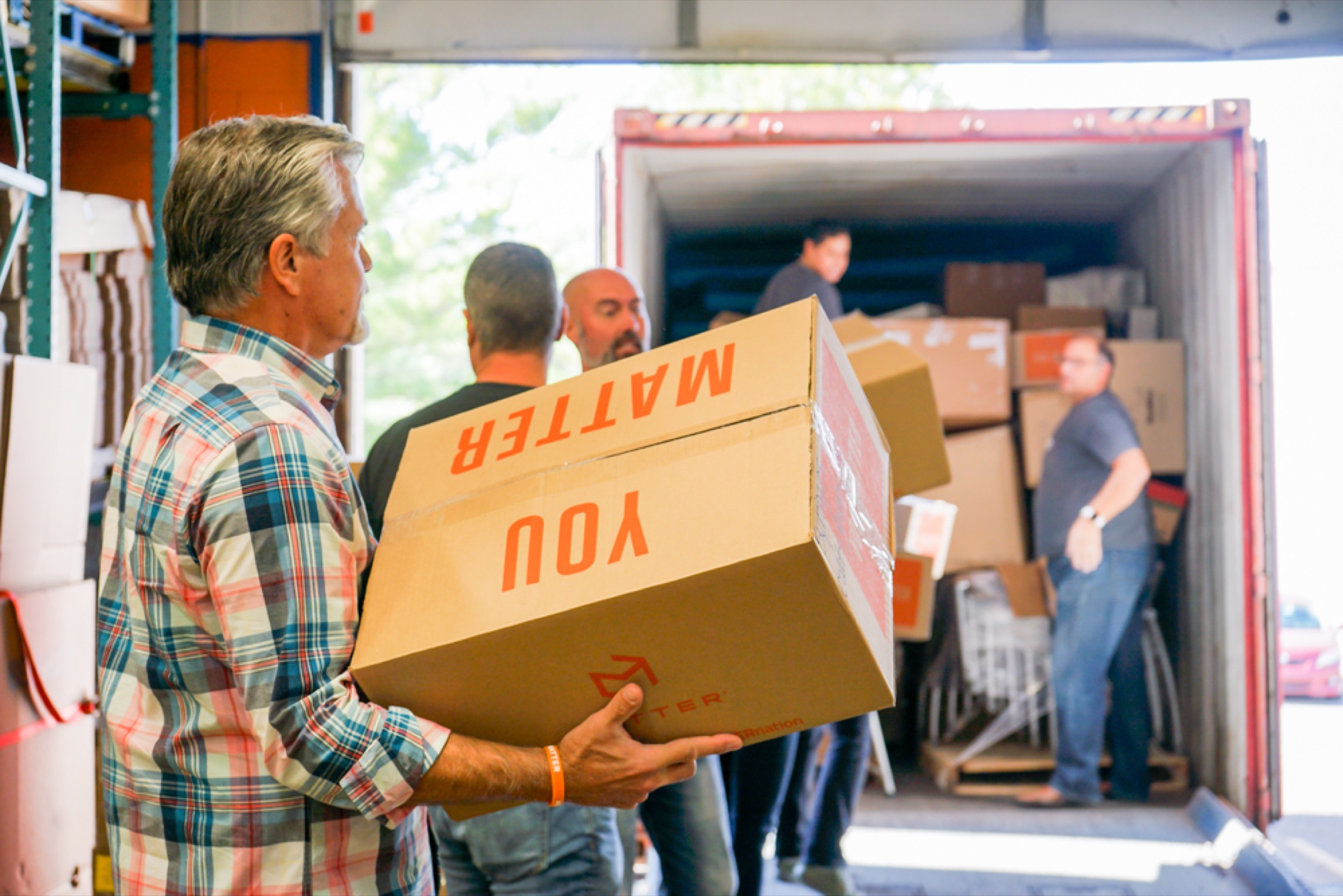 Supplies being loaded into a truck for distribution